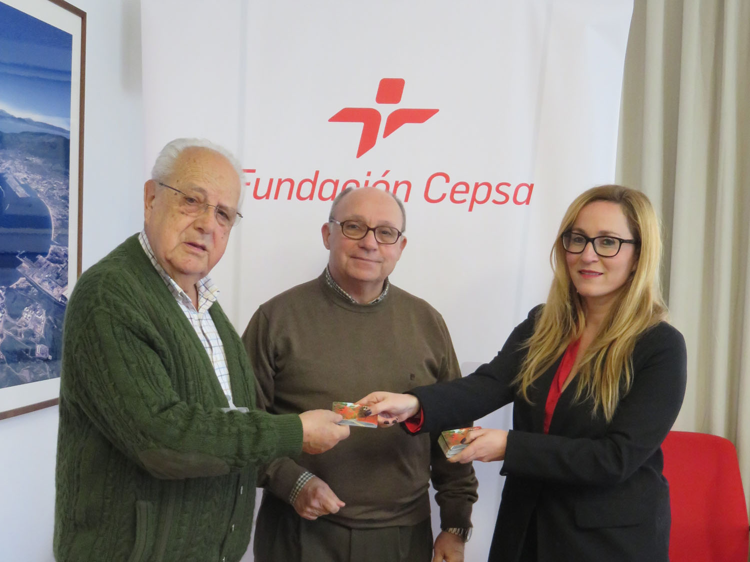 Fundación Cepsa representative Estrella Blanco with Food Bank chairman José Serrano, and member José Cañete